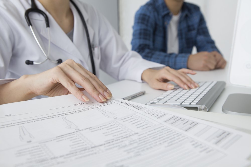 Doctor,To,Explain,To,The,Patient,While,Checking,Documents,And